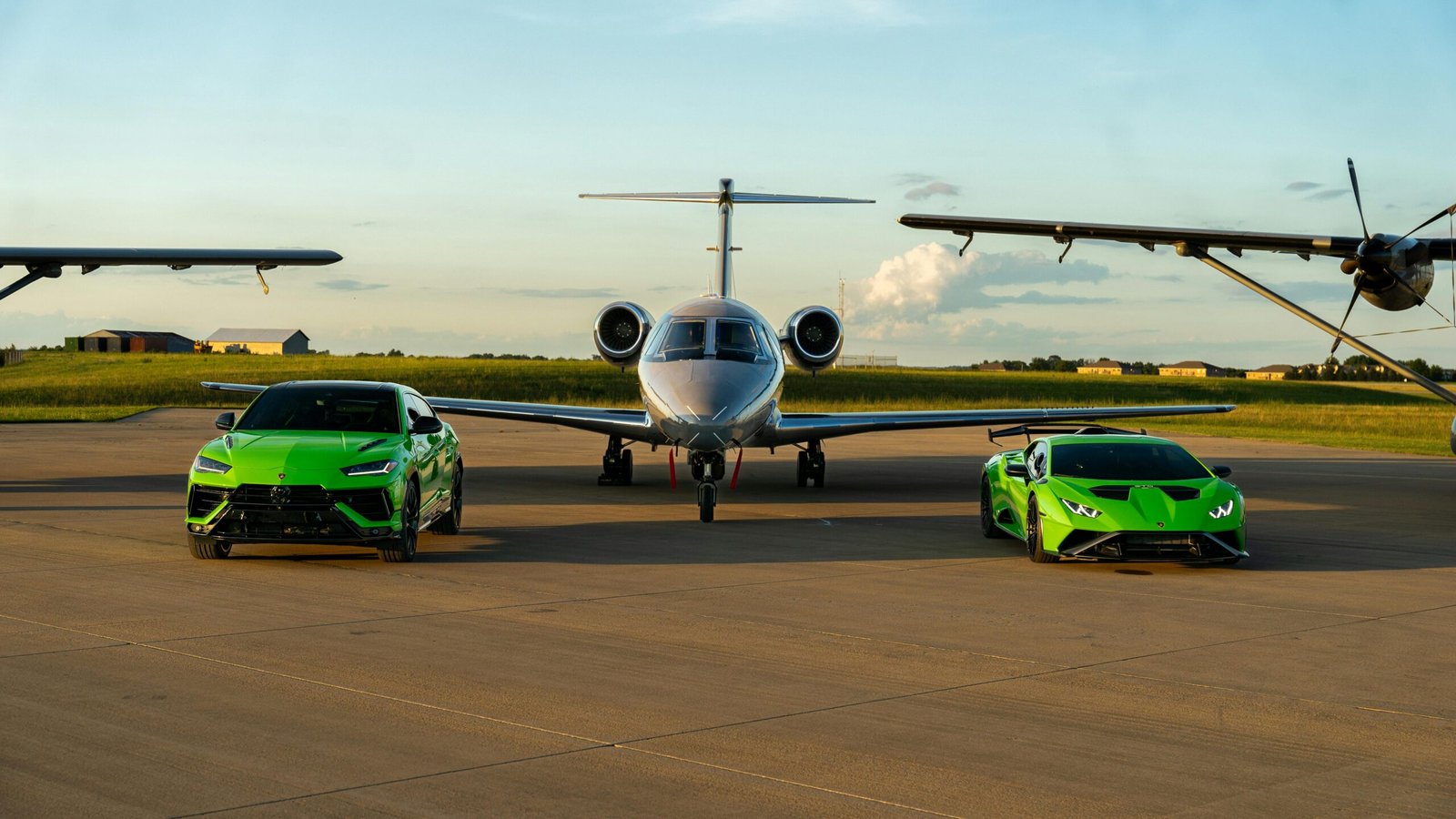 Luxury green cars and private jet on runway in Illinois, sunset scene.